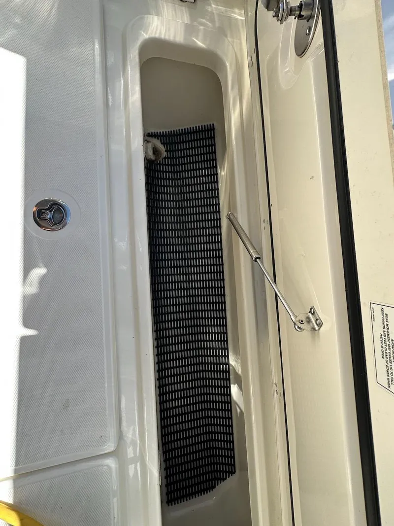 Slide: The Image of Boston Whaler 350 Realm 2019 boat storage compartment with black mat. - 42