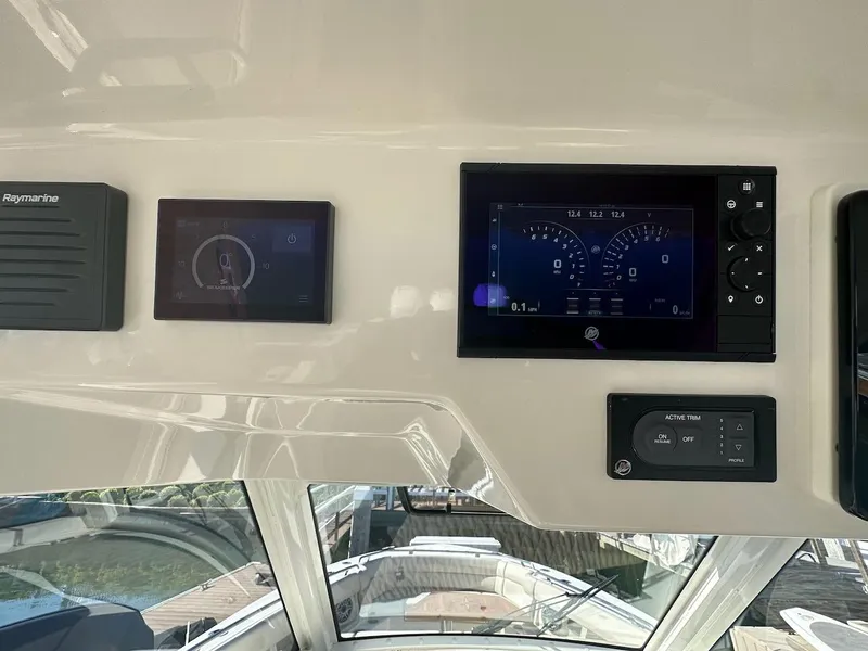 Slide: The Image of 2019 Boston Whaler 350 Realm dashboard with Raymarine displays and controls. - 9