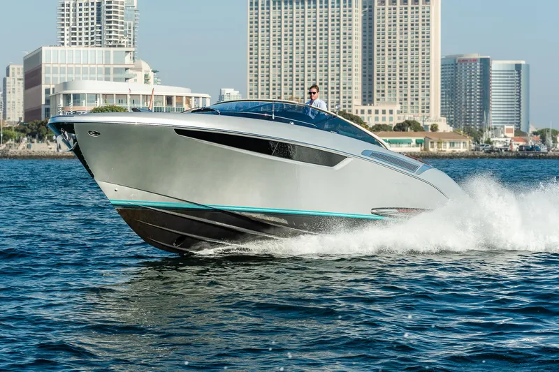 The Image of 2024 Riva 38 Rivamare luxury yacht cruising on water near city skyline. - 0