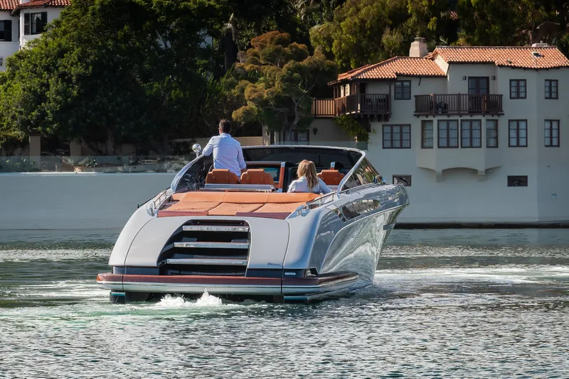 Slide: The Image of 2024 Riva 38 Rivamare luxury yacht cruising near waterfront homes. - 10