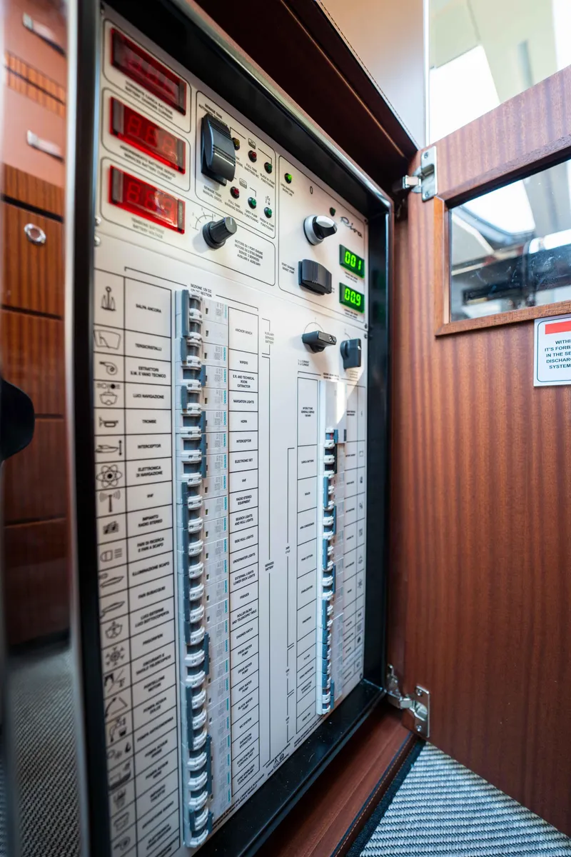 Slide: The Image of Electrical control panel inside 2024 Riva 38 Rivamare yacht, featuring switches and indicators. - 13