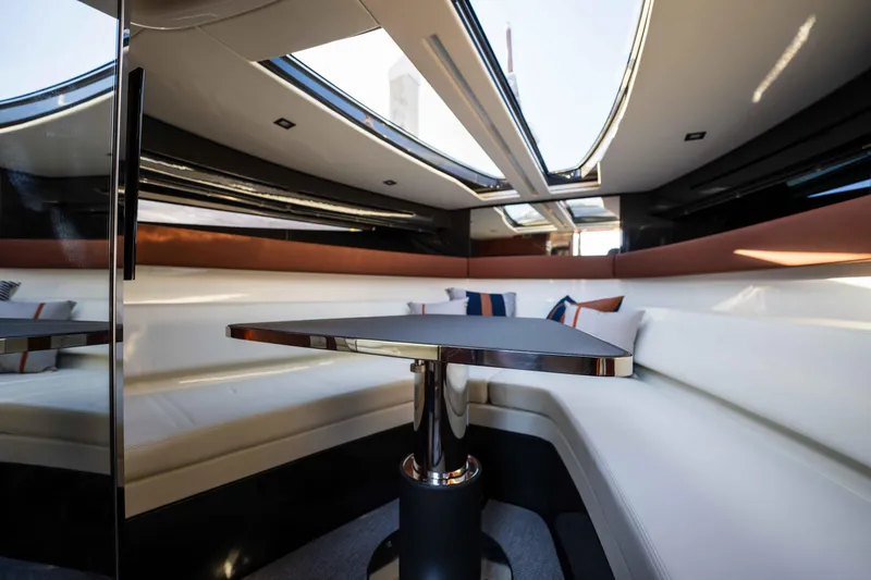 Slide: The Image of 2024 Riva 38 Rivamare interior with sleek design, white seating, and modern table. - 17