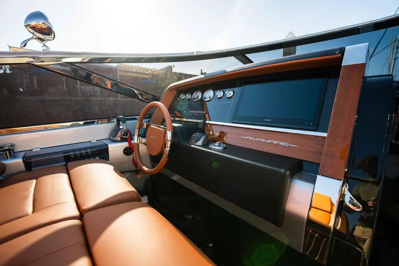 Slide: The Image of 2024 Riva 38 Rivamare luxury yacht interior with leather seating and modern dashboard. - 21