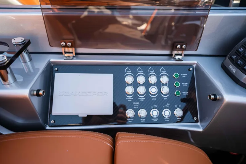 Slide: The Image of Control panel of 2024 Riva 38 Rivamare yacht with switches and leather seating. - 23