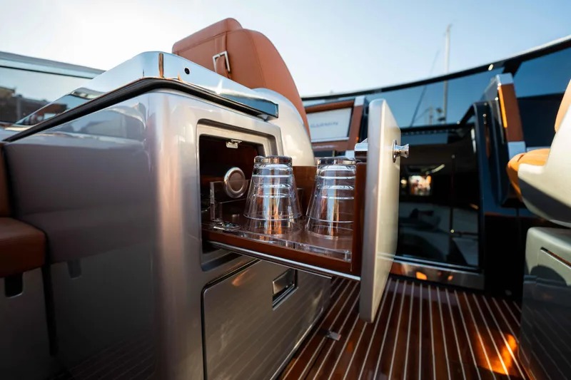 Slide: The Image of 2024 Riva 38 Rivamare yacht interior with open cabinet and glass holders. - 26