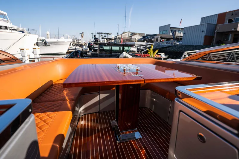 Slide: The Image of Luxurious 2024 Riva 38 Rivamare yacht interior with elegant wood and leather seating. - 28