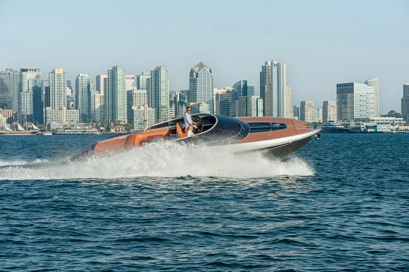 Slide: The Image of 2024 Riva 38 Rivamare cruising on water with city skyline backdrop. - 3