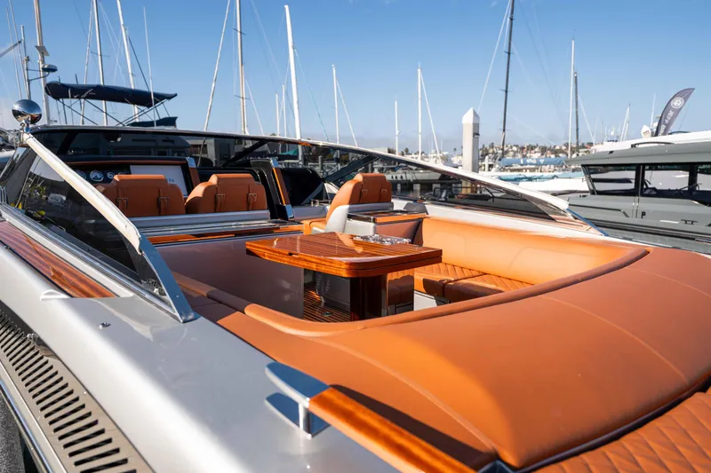 Slide: The Image of 2024 Riva 38 Rivamare luxury yacht with elegant leather seating and wooden table. - 30