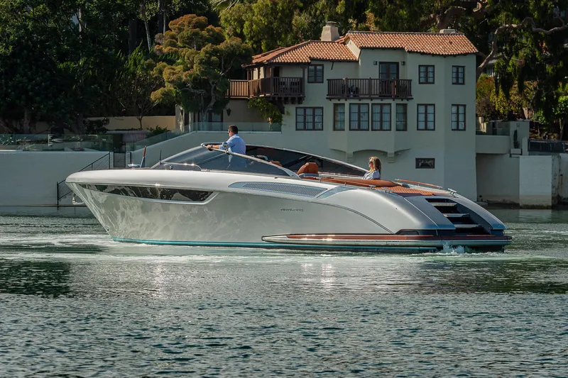 Slide: The Image of 2024 Riva 38 Rivamare luxury yacht cruising near waterfront villa. - 6