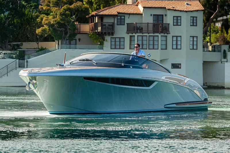 Slide: The Image of 2024 Riva 38 Rivamare luxury yacht cruising near waterfront villa. - 7
