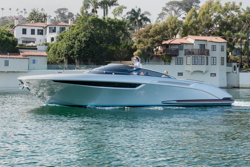 Slide: The Image of 2024 Riva 38 Rivamare luxury yacht cruising near waterfront homes. - 8