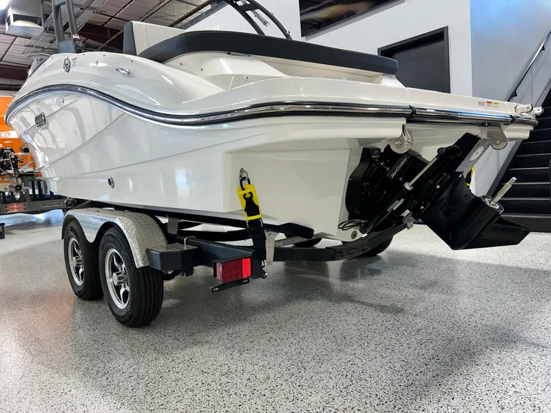 Slide: The Image of 2025 Sea Ray SPX 210 boat on trailer, displayed indoors, rear view. - 11