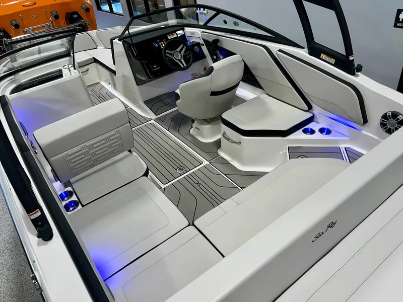 Slide: The Image of 2025 Sea Ray SPX 210 boat interior with modern seating and ambient lighting. - 16