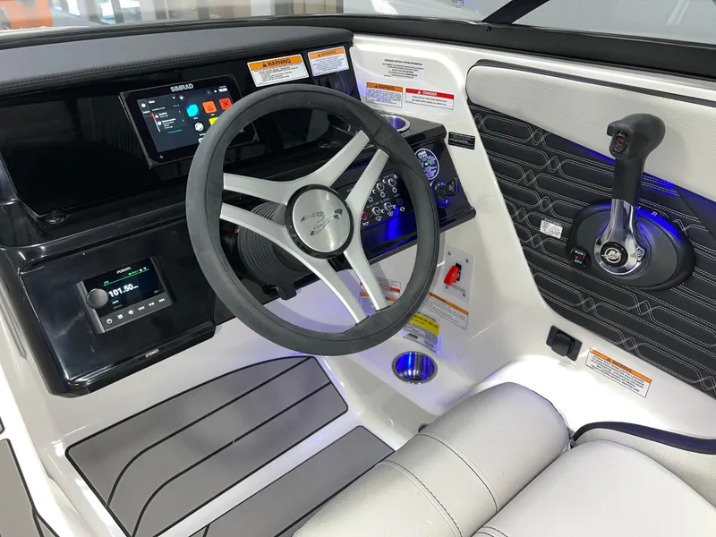 Slide: The Image of 2025 Sea Ray SPX 210 boat dashboard with steering wheel and control panel. - 18