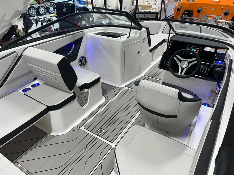 Slide: The Image of 2025 Sea Ray SPX 210 boat interior with modern seating and sleek dashboard design. - 20