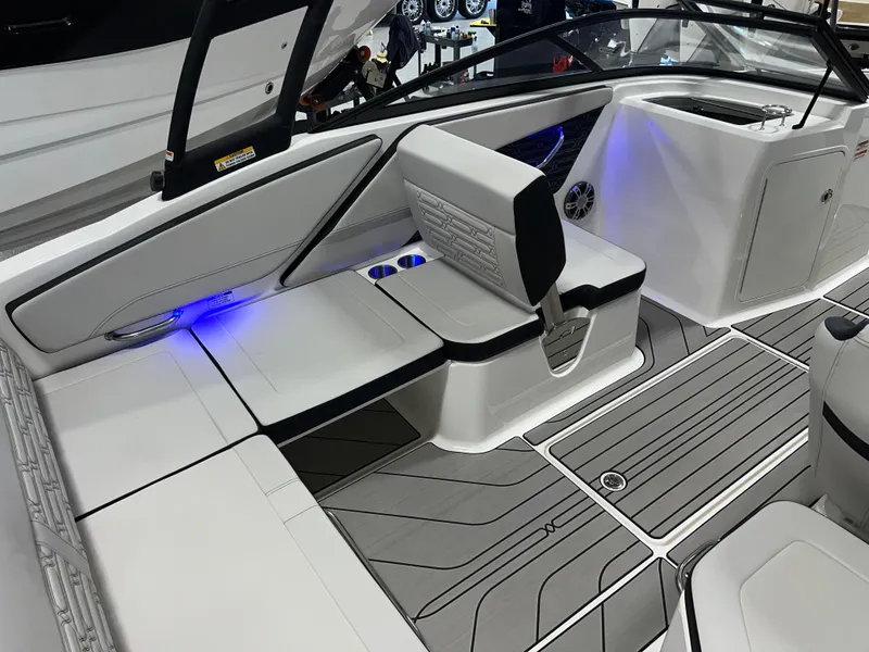Slide: The Image of 2025 Sea Ray SPX 210 boat interior with modern seating and ambient lighting. - 21
