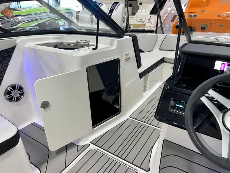 Slide: The Image of 2025 Sea Ray SPX 210 boat interior with modern dashboard and seating. - 24