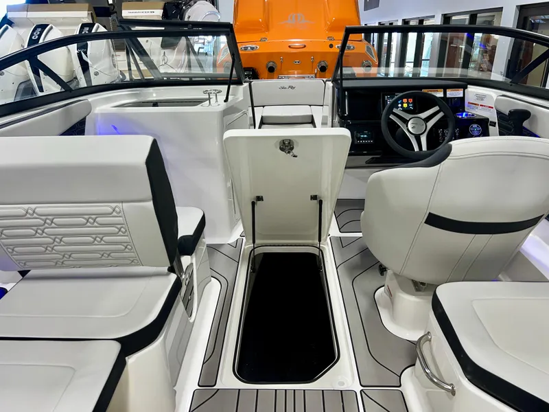 Slide: The Image of 2025 Sea Ray SPX 210 boat interior with modern seating and sleek dashboard design. - 26