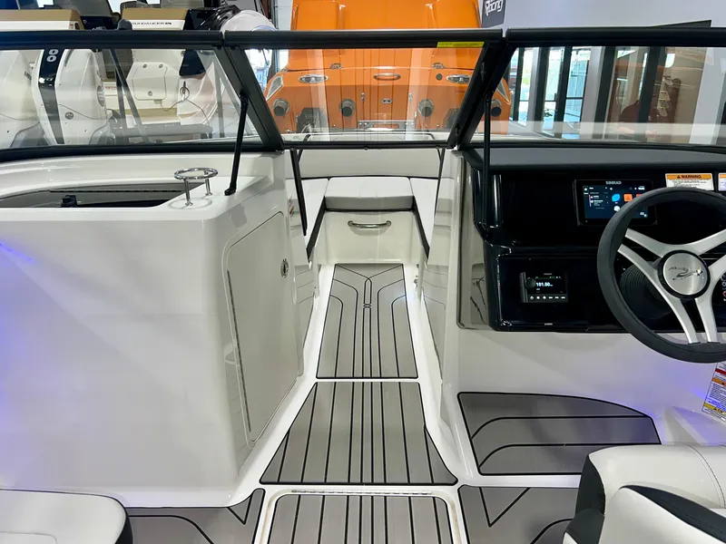 Slide: The Image of 2025 Sea Ray SPX 210 boat interior with modern dashboard and sleek design. - 27
