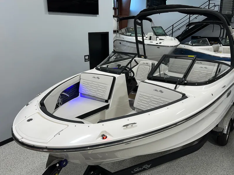 Slide: The Image of 2025 Sea Ray SPX 210 boat with sleek design and modern interior in showroom. - 3