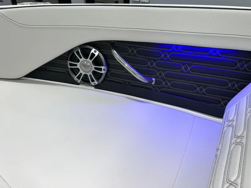 Slide: The Image of 2025 Sea Ray SPX 210 interior with sleek design, blue LED lighting, and premium speaker. - 31