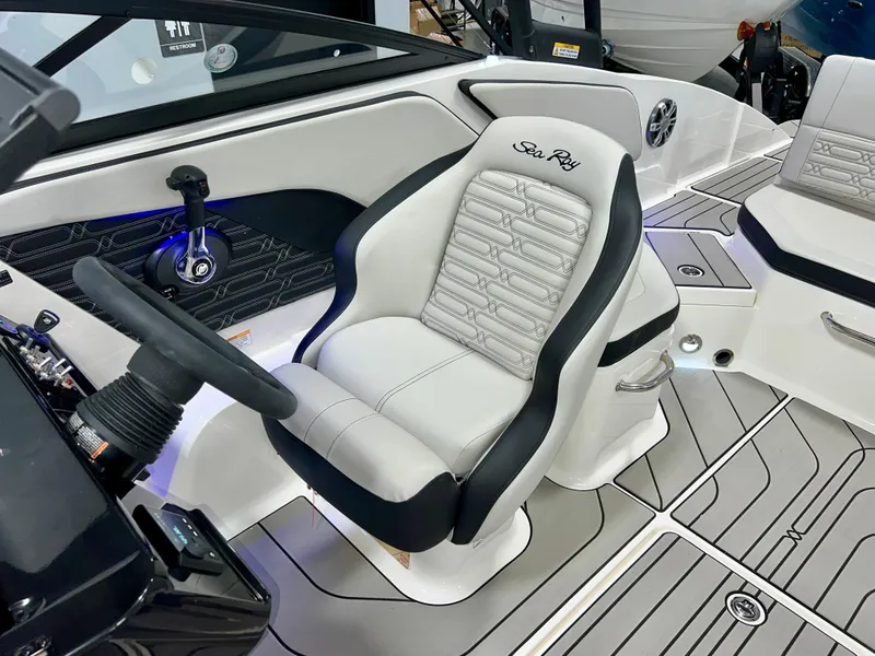 Slide: The Image of 2025 Sea Ray SPX 210 boat interior with steering wheel and plush seating. - 37