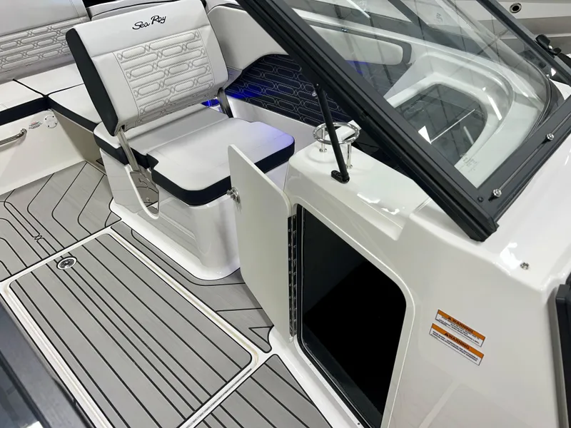 Slide: The Image of 2025 Sea Ray SPX 210 boat interior with seating and storage compartment. - 39