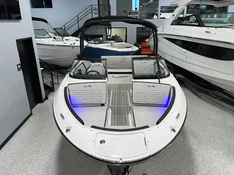 Slide: The Image of 2025 Sea Ray SPX 210 boat in showroom, featuring sleek design and modern interior. - 4