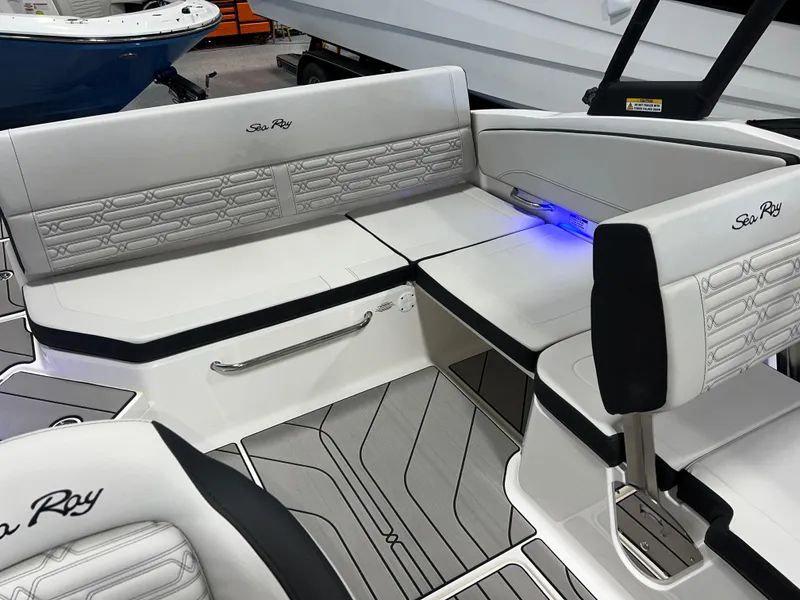 Slide: The Image of 2025 Sea Ray SPX 210 boat interior with modern seating and ambient lighting. - 40