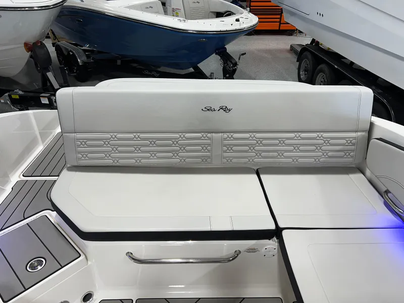 Slide: The Image of 2025 Sea Ray SPX 210 boat interior with white cushioned seating and sleek design. - 42