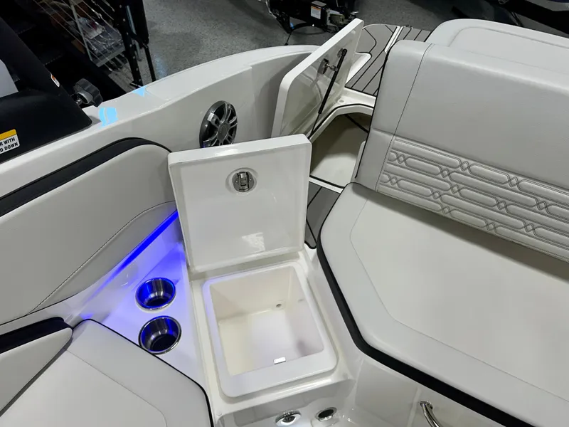 Slide: The Image of 2025 Sea Ray SPX 210 boat interior with seating, cup holders, and storage compartment. - 46