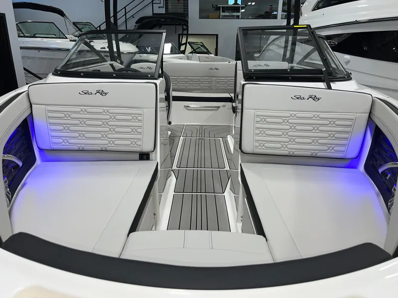 Slide: The Image of 2025 Sea Ray SPX 210 boat interior with luxurious seating and ambient lighting. - 5