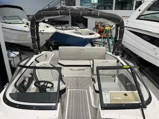 Slide: The Image of 2025 Sea Ray SPX 210 boat interior with seating and steering wheel. - 67