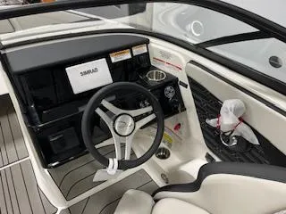Slide: The Image of 2025 Sea Ray SPX 210 boat interior with steering wheel and dashboard. - 71
