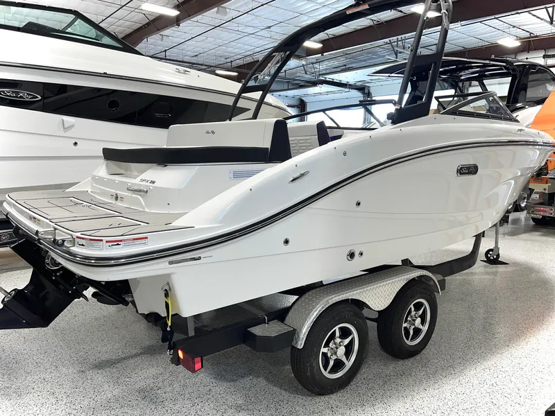Slide: The Image of 2025 Sea Ray SPX 210 boat on trailer in showroom setting. - 8