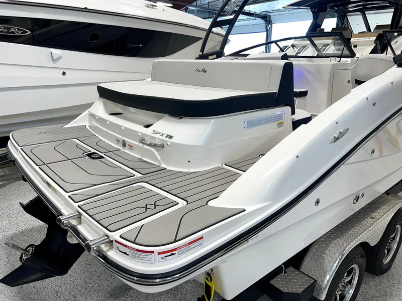 Slide: The Image of 2025 Sea Ray SPX 210 boat, sleek design, spacious deck, modern features, on trailer. - 9