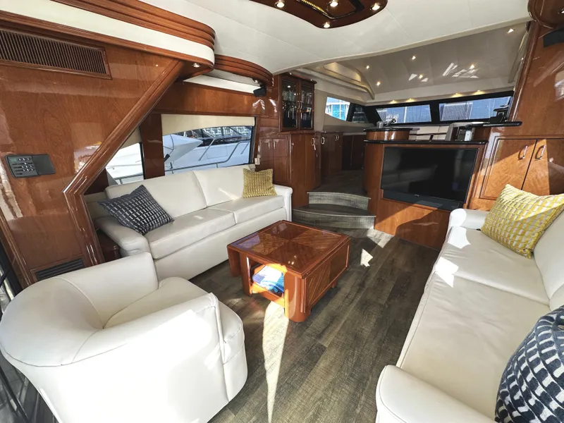 Slide: The Image of Luxurious 2004 Marquis 59 yacht interior with elegant wood finishes and comfortable seating. - 1