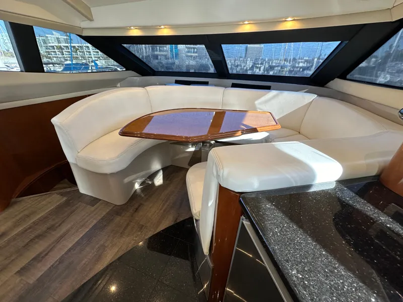 Slide: The Image of Luxurious 2004 Marquis 59 yacht interior with elegant seating and panoramic windows. - 11