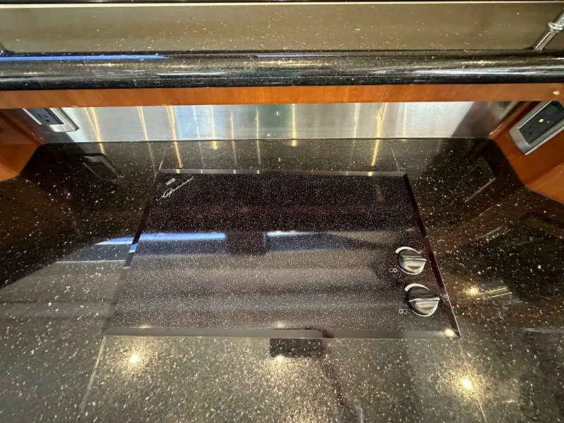 Slide: The Image of Luxury yacht kitchen countertop with sleek black finish, Marquis 59, 2004 model. - 15