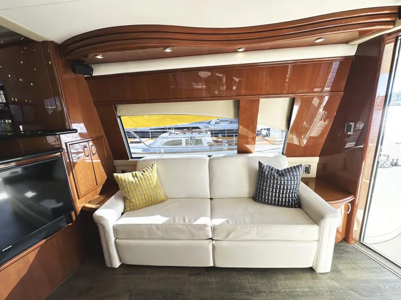Slide: The Image of Luxurious 2004 Marquis 59 yacht interior with white sofa and wooden accents. - 3