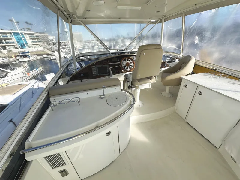 Slide: The Image of Luxurious 2004 Marquis 59 yacht helm with modern controls and panoramic marina view. - 38