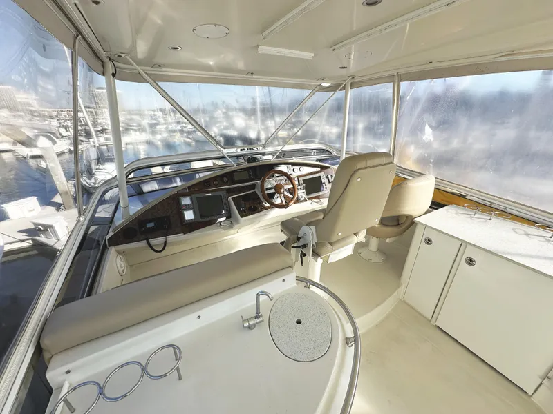 Slide: The Image of Interior of 2004 Marquis 59 yacht, featuring helm and seating area. - 39
