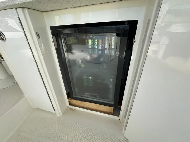 Slide: The Image of Built-in mini fridge on 2004 Marquis 59 yacht, featuring glass door and sleek design. - 42