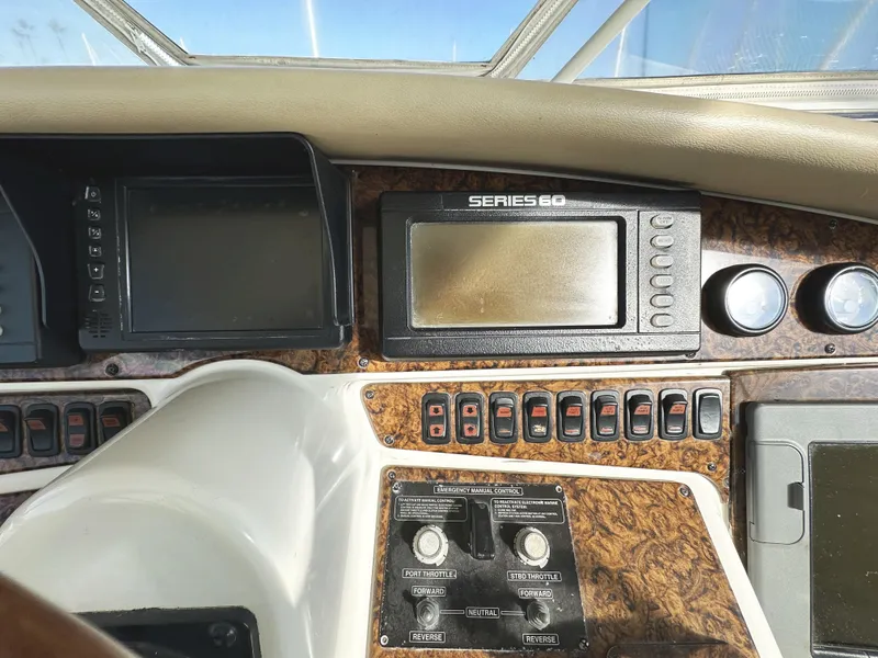 Slide: The Image of Dashboard of a 2004 Marquis 59 yacht with navigation controls and displays. - 47