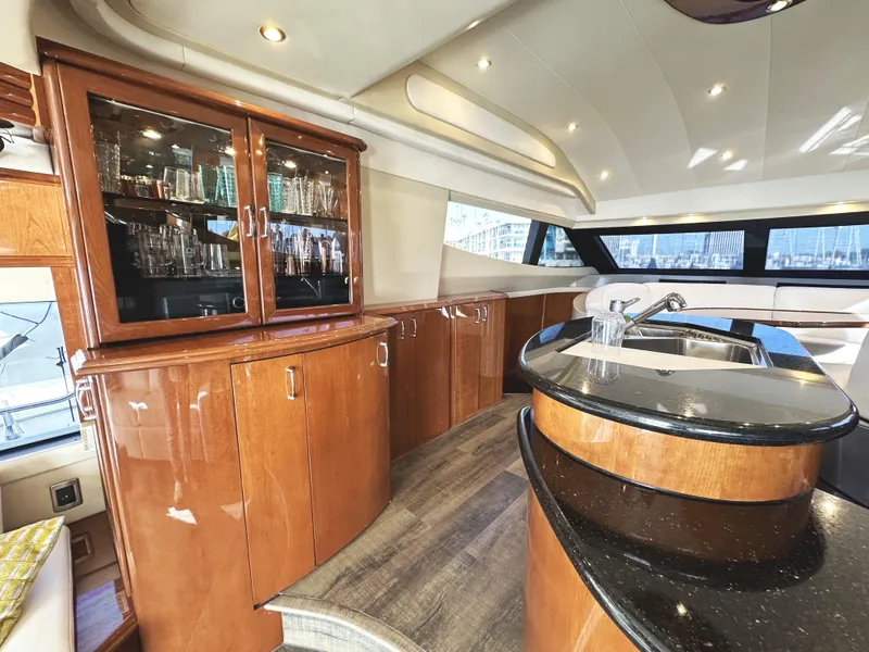 Slide: The Image of Luxurious interior of a 2004 Marquis 59 yacht with elegant wood cabinetry and modern amenities. - 9
