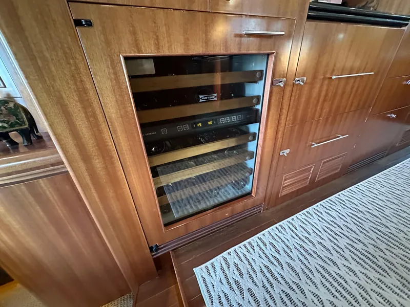 Slide: The Image of Wine cooler in 2007 Horizon 73 Motor Yacht's elegant wooden interior. - 24