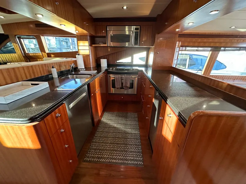Slide: The Image of Luxurious kitchen interior of 2007 Horizon 73 Motor Yacht with wood cabinetry and modern appliances. - 25