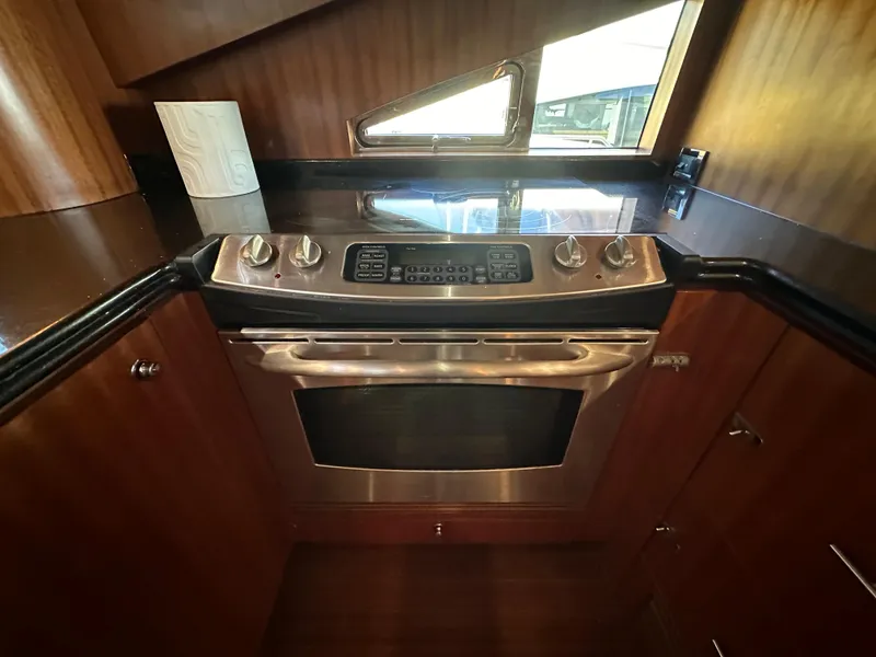 Slide: The Image of Luxurious kitchen in 2007 Horizon 73 Motor Yacht with modern stainless steel oven. - 27