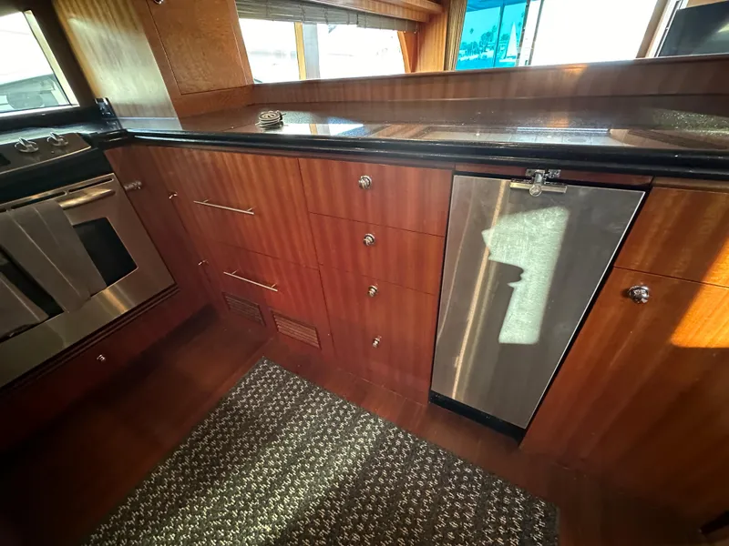Slide: The Image of Interior of 2007 Horizon 73 Motor Yacht kitchen with wood cabinetry and stainless steel appliances. - 31