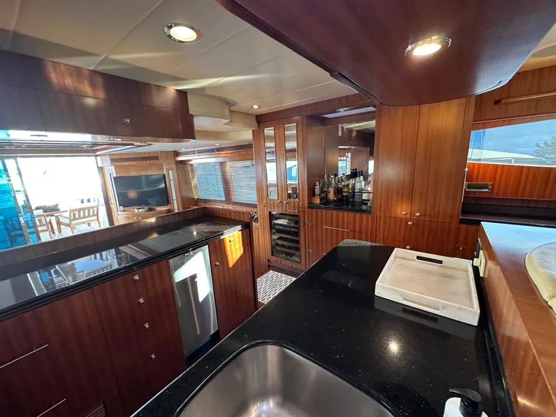Slide: The Image of Luxurious interior of 2007 Horizon 73 Motor Yacht with modern kitchen and wood finishes. - 32